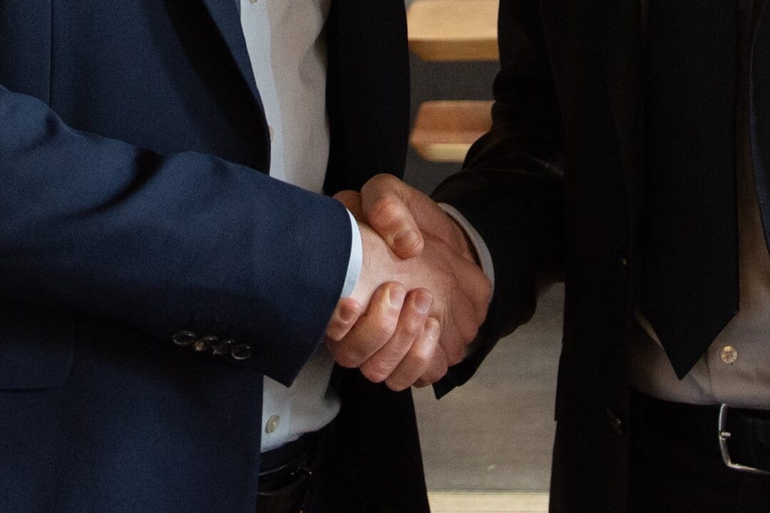 Two business partners shaking hands after a meeting