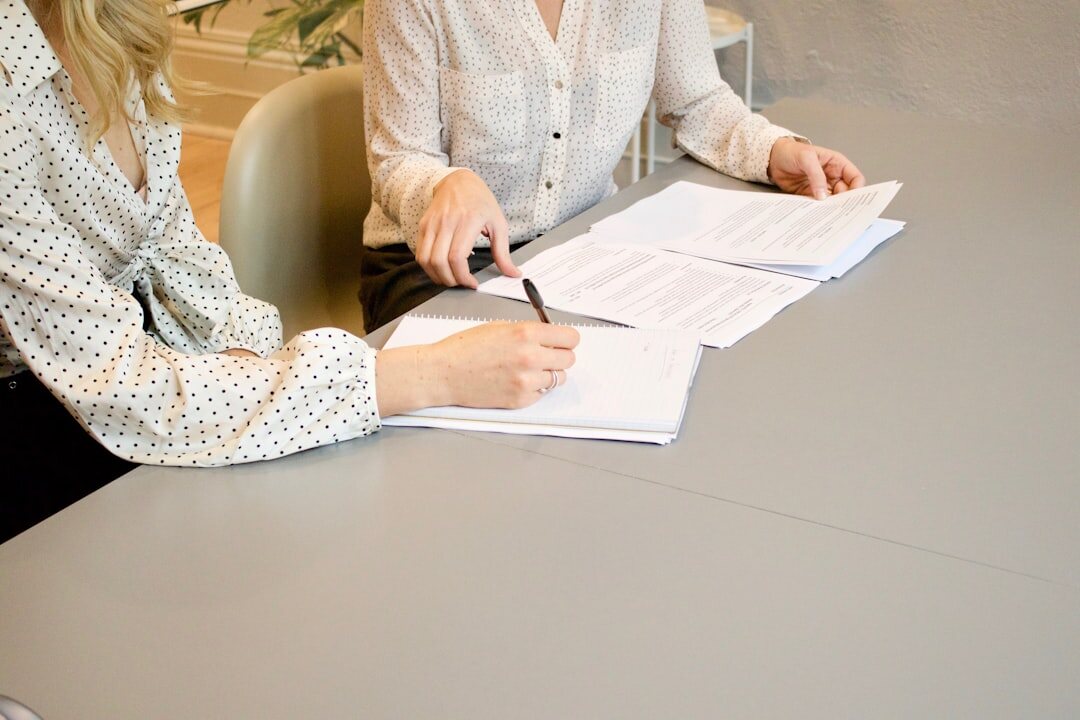 Overhead view of a business meeting with laptops and notes