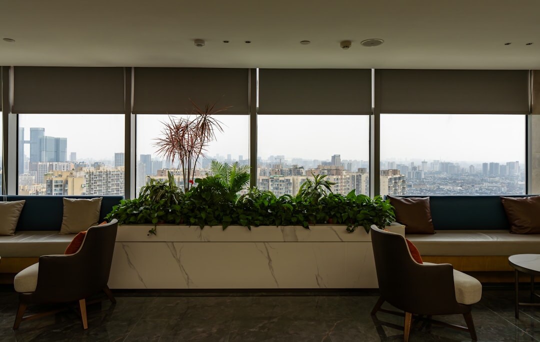 Business professionals networking in a modern lobby with city view